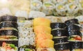 Fresh sushi rolls with salmon, avocado, tuna and cucumber. Maki plate with rice and nori. Delicious Japanese food with sushi roll