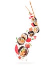 Fresh sushi rolls with various ingredients in the air on white background Royalty Free Stock Photo