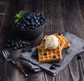 Fresh sweet blueberry with aromatic belgian waffels vanilla ice cream and honey dark wood table