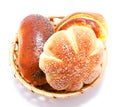 Fresh sweet buns and rolls with poppy and cream in the basket Royalty Free Stock Photo