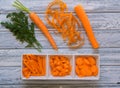 Fresh sweet carrot on light wooden background with different cuts Royalty Free Stock Photo