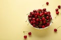 Fresh sweet cherries bowl on beige background, top view Royalty Free Stock Photo