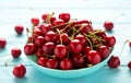 Fresh sweet cherries bowl on blue background. Top view Royalty Free Stock Photo
