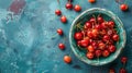 Fresh sweet cherries bowl with leaves in water drops on blue stone background, top view Royalty Free Stock Photo