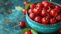 Fresh sweet cherries bowl with leaves in water drops on blue stone background, top view Royalty Free Stock Photo