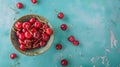 Fresh sweet cherries bowl with leaves in water drops on blue stone background, top view Royalty Free Stock Photo