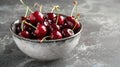 Fresh sweet cherries bowl with leaves in water drops on blue stone background, top view Royalty Free Stock Photo