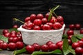 cherry cherries bowl with leaves on wooden desktop table. water drops on Fresh sour cherry