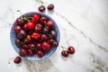 Fresh sweet cherries bowl on marble background. Top view with copy space Royalty Free Stock Photo