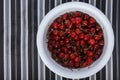 Fresh sweet cherry in a white cup on a striped background Royalty Free Stock Photo