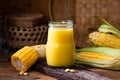 Fresh sweet corn juice (corn milk) and corn on wood background Royalty Free Stock Photo