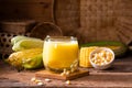 Fresh sweet corn juice (corn milk) and corn on wood background Royalty Free Stock Photo