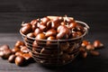 Fresh sweet edible chestnuts in basket on black table, closeup Royalty Free Stock Photo