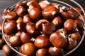 Fresh sweet edible chestnuts in basket, closeup Royalty Free Stock Photo