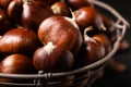 Fresh sweet edible chestnuts in basket, closeup Royalty Free Stock Photo