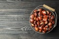 Fresh sweet edible chestnuts on black wooden  table, top view. Space for text Royalty Free Stock Photo