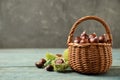 Fresh sweet edible chestnuts in wicker basket on blue wooden table. Space for text Royalty Free Stock Photo