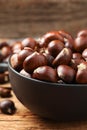 Fresh sweet edible chestnuts on wooden table, closeup Royalty Free Stock Photo