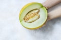 Fresh sweet melon in hands on a light background, top view Royalty Free Stock Photo