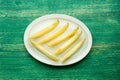 Fresh sweet melon on plate on the wooden table, selective focus. Royalty Free Stock Photo