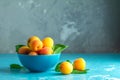 Fresh sweet orange apricots in blue bowl Royalty Free Stock Photo
