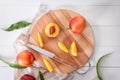 Fresh sweet peaches with wooden board on white table Royalty Free Stock Photo