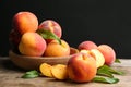 Fresh sweet peaches on wooden table against black Royalty Free Stock Photo
