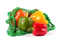 Fresh sweet peppers in a green string bag Royalty Free Stock Photo