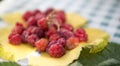 Fresh and sweet raspberries on yellow grape leaf in autumn,last harvest before winter Royalty Free Stock Photo