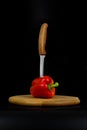 Fresh sweet red pepper on wooden board with black background. Royalty Free Stock Photo