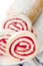 Fresh sweet roll with strawberry jam and powdered sugar on a plate and white towel Royalty Free Stock Photo