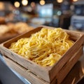 Fresh tagliatelle pasta in a wooden box with blurred background. Royalty Free Stock Photo