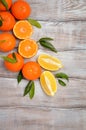 Fresh tangerine clementine and lemons with leaves on wooden background Royalty Free Stock Photo