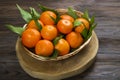 Fresh tangerine oranges on a wooden table. Peeled mandarin. Halves, slices and whole clementines closeup. Royalty Free Stock Photo