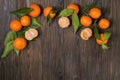 Fresh tangerine oranges on a wooden table. Peeled mandarin. Halves, slices and whole clementines closeup. Royalty Free Stock Photo