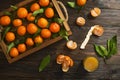 Fresh tangerine oranges on a wooden table. Peeled mandarin. Halves, slices and whole clementines closeup.