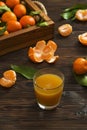 Fresh tangerine oranges on a wooden table. Peeled mandarin. Halves, slices and whole clementines closeup.