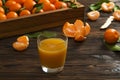 Fresh tangerine oranges on a wooden table. Peeled mandarin. Halves, slices and whole clementines closeup.