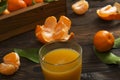 Fresh tangerine oranges on a wooden table. Peeled mandarin. Halves, slices and whole clementines closeup.