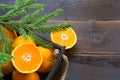 Fresh tangerines in brown box on wooden background with green fir branches. Frame, copy space, holiday and winter fragrance, new Royalty Free Stock Photo