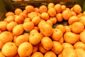Fresh tangerines in the store close-up. Crates full of ripe mandarin and clementines oranges for sale at the counter Royalty Free Stock Photo