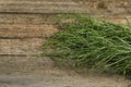 Fresh tarragon sprigs on wooden table, closeup. Space for text Royalty Free Stock Photo