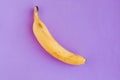 Fresh tasty banana on purple background.