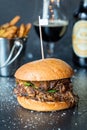 Fresh Tasty Big Chicken Burger with Cheese, Sauce and Fries on Dark Stone Background, Beer on the Background Royalty Free Stock Photo