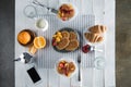 Fresh tasty breakfast with waffles, coffee and smartphone with blank screen on table Royalty Free Stock Photo