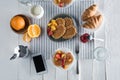 Fresh tasty breakfast with waffles, coffee and smartphone with blank screen on table Royalty Free Stock Photo