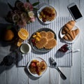 Fresh tasty breakfast with waffles and smartphone with blank screen on table Royalty Free Stock Photo