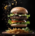 Fresh tasty burger flying air and Fries with little steam on dark background. Fast Food. Unhealthy but delicious food