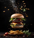 Fresh tasty burger flying air and Fries with little steam on dark background. Fast Food. Unhealthy but delicious food