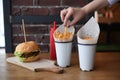 Fresh tasty burger and french fries on wooden table Royalty Free Stock Photo